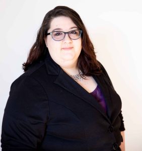 Professional headshot of a CTEDU team member wearing a black blazer and glasses