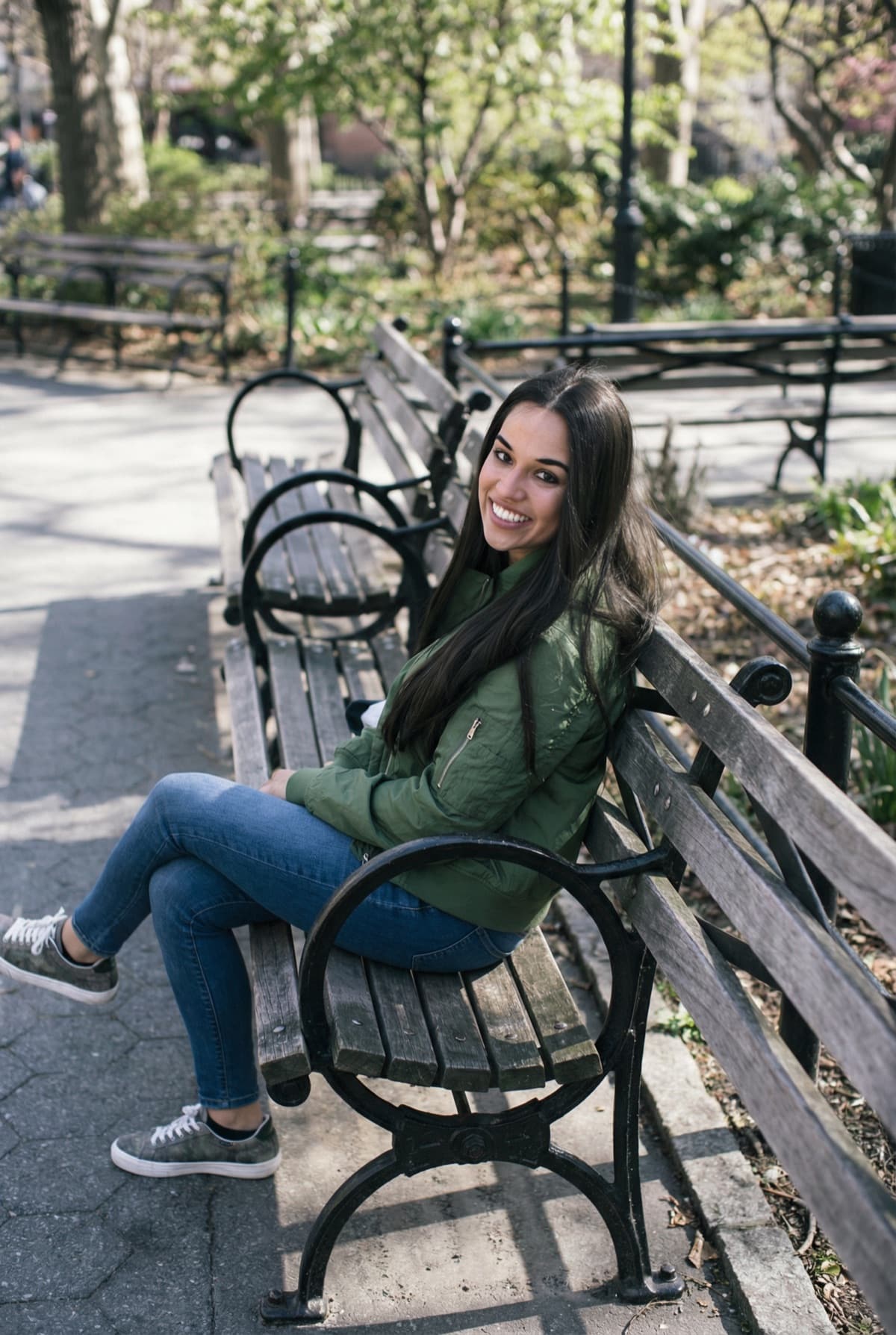 Woman sitting on park bench smiling