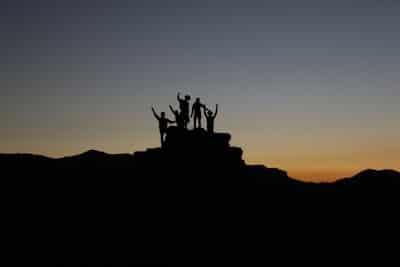 group in silhouette, cheering