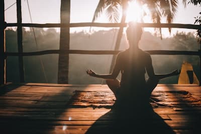woman meditating at sunrise