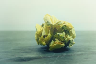 a crumpled piece of yellow paper