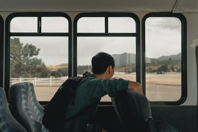man daydreaming in front of windows