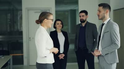 four people in a group, talking