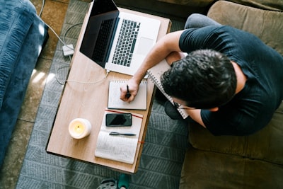 a man taking notes at a desk