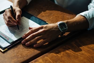 a man taking notes on a notepad