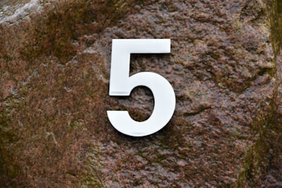 the number 5 on a stone background