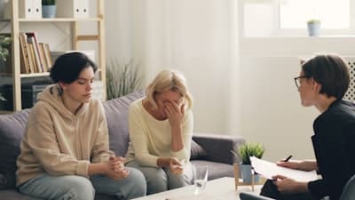 two people on a couch having a counseling session
