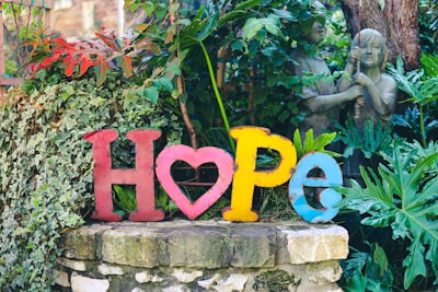 a colorful wooden sign saying hope