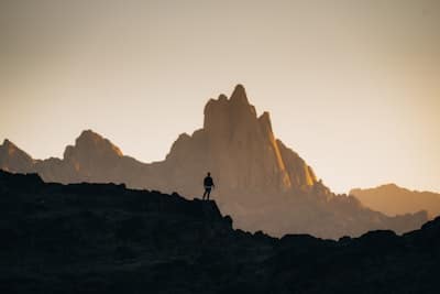 person-standing-in-front-of mountain